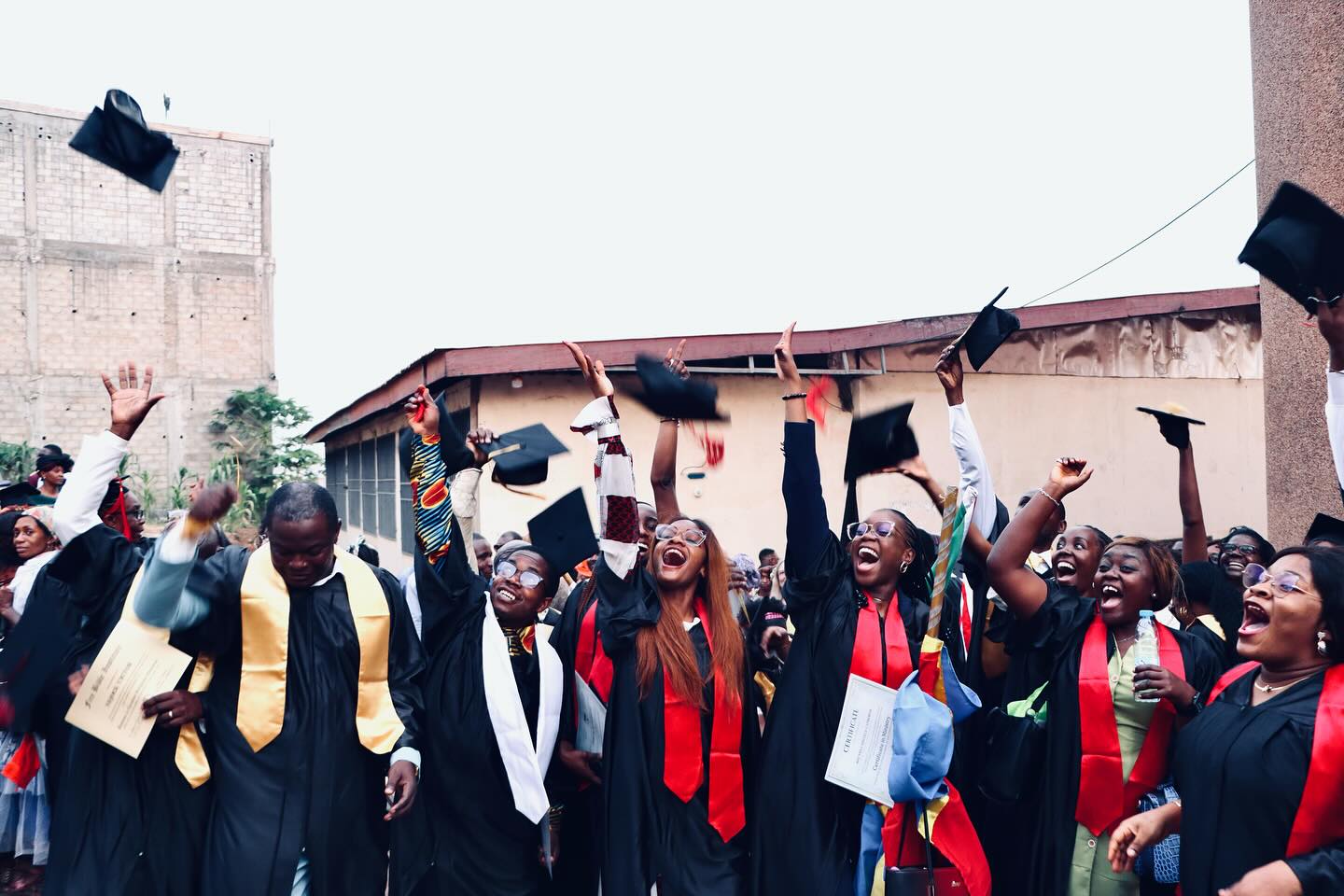 FIRE Bible Institute graduates celebrating with caps in the air